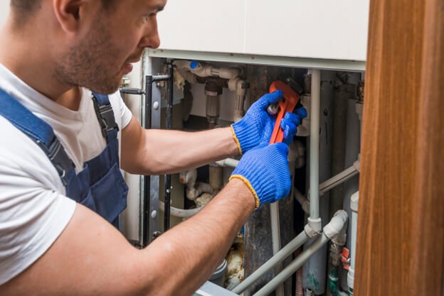 sanitary technician working with pipes