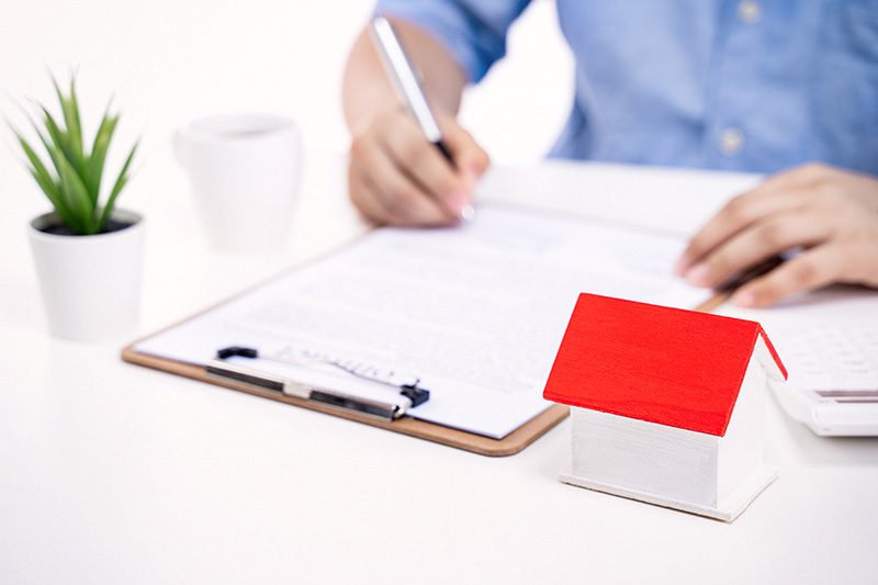 Person writing on a document