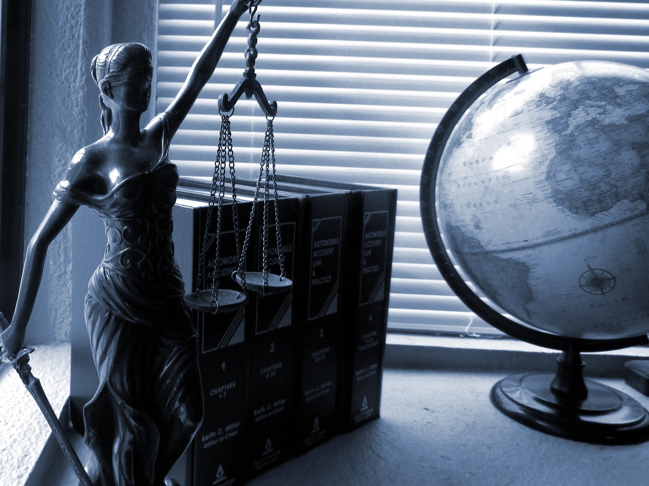 Lady-justice statue with globe an books in sepia shade