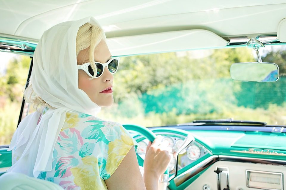 50's recreation with lady in automobile
