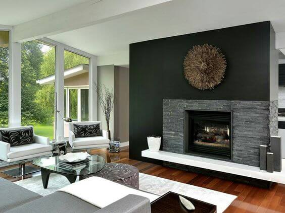 dark stone veneer and a black wall fireplace
