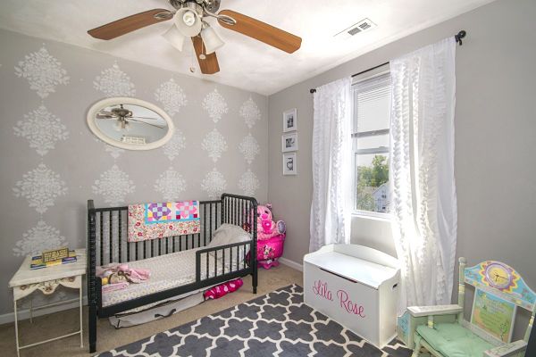 crib and toddler bed in small room