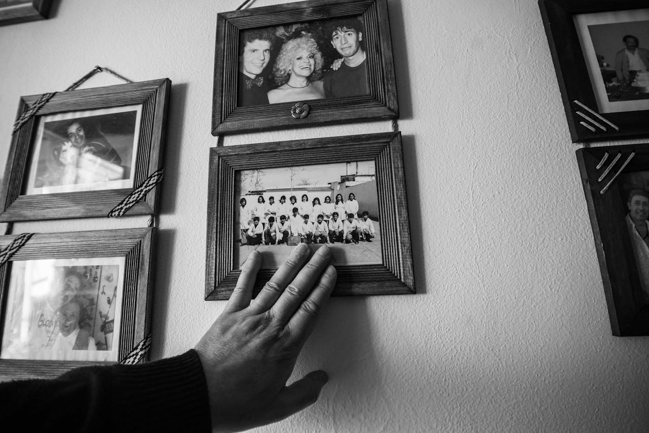 Hand Touching Black and White Family Photographs