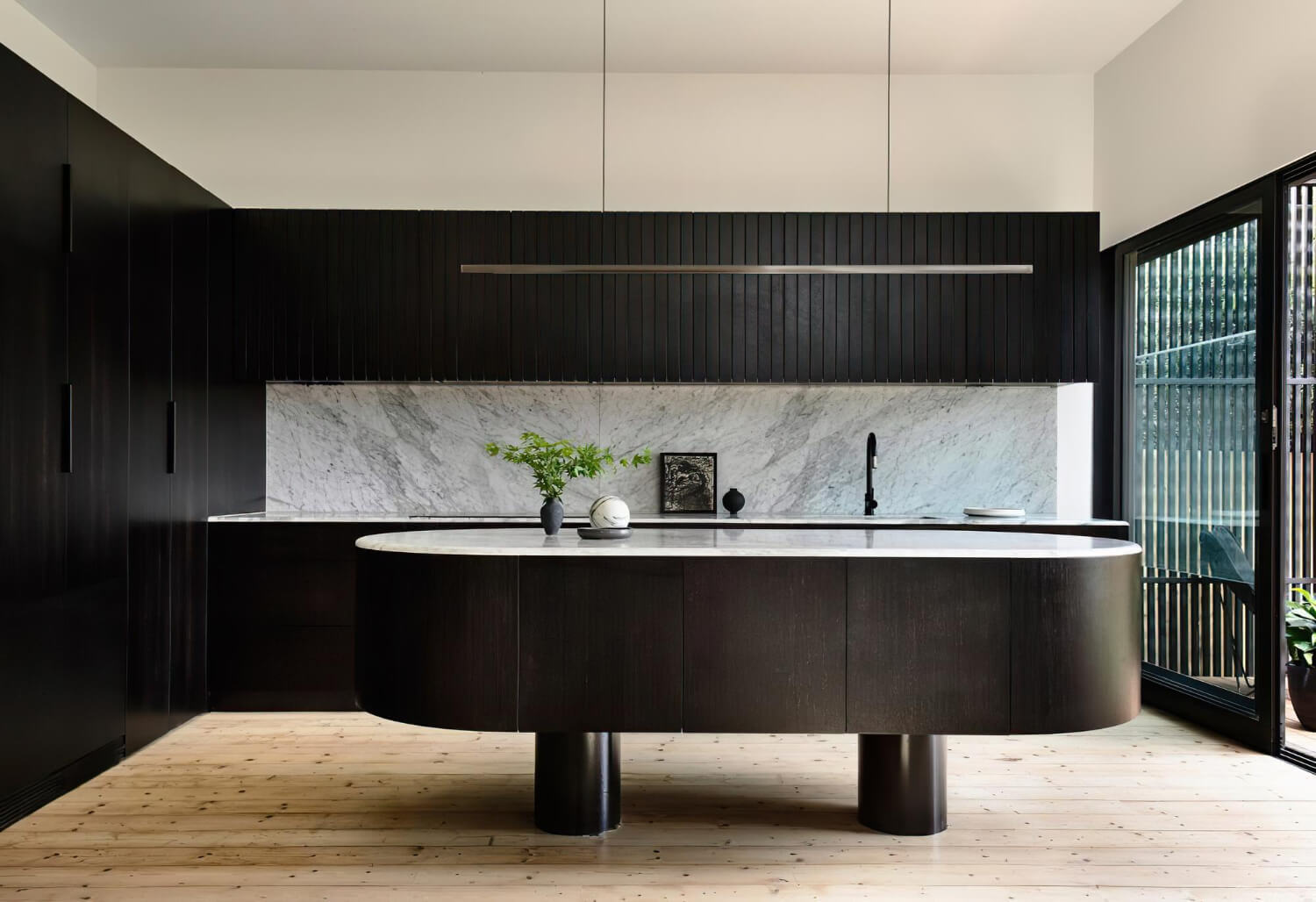 A kitchen with a black and white marble counter top and a black and white marble countertop