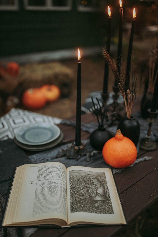 Table with black candles and book