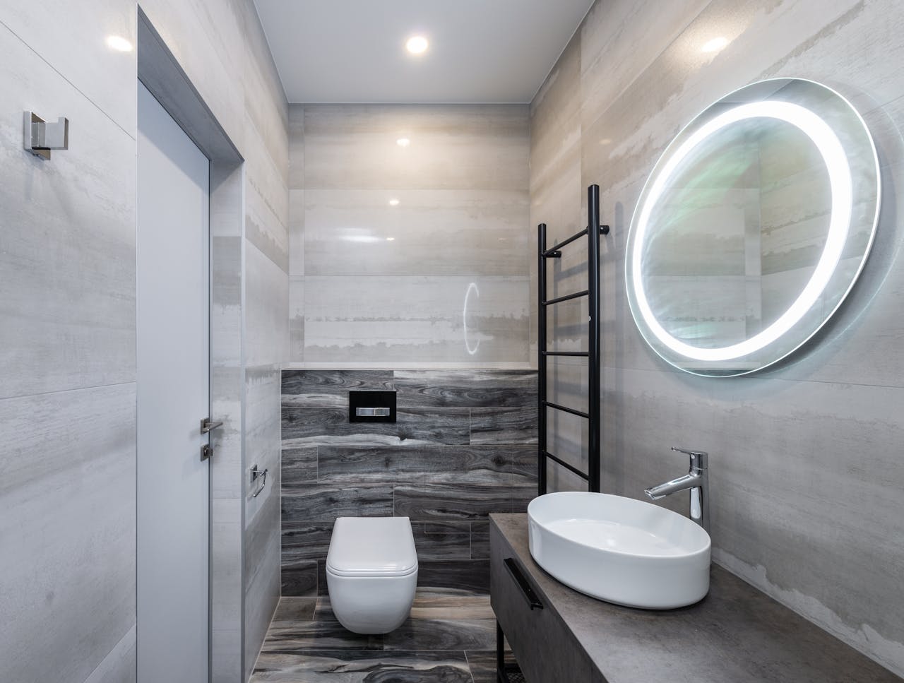 Modern bathroom interior with washbasin under mirror with shiny light