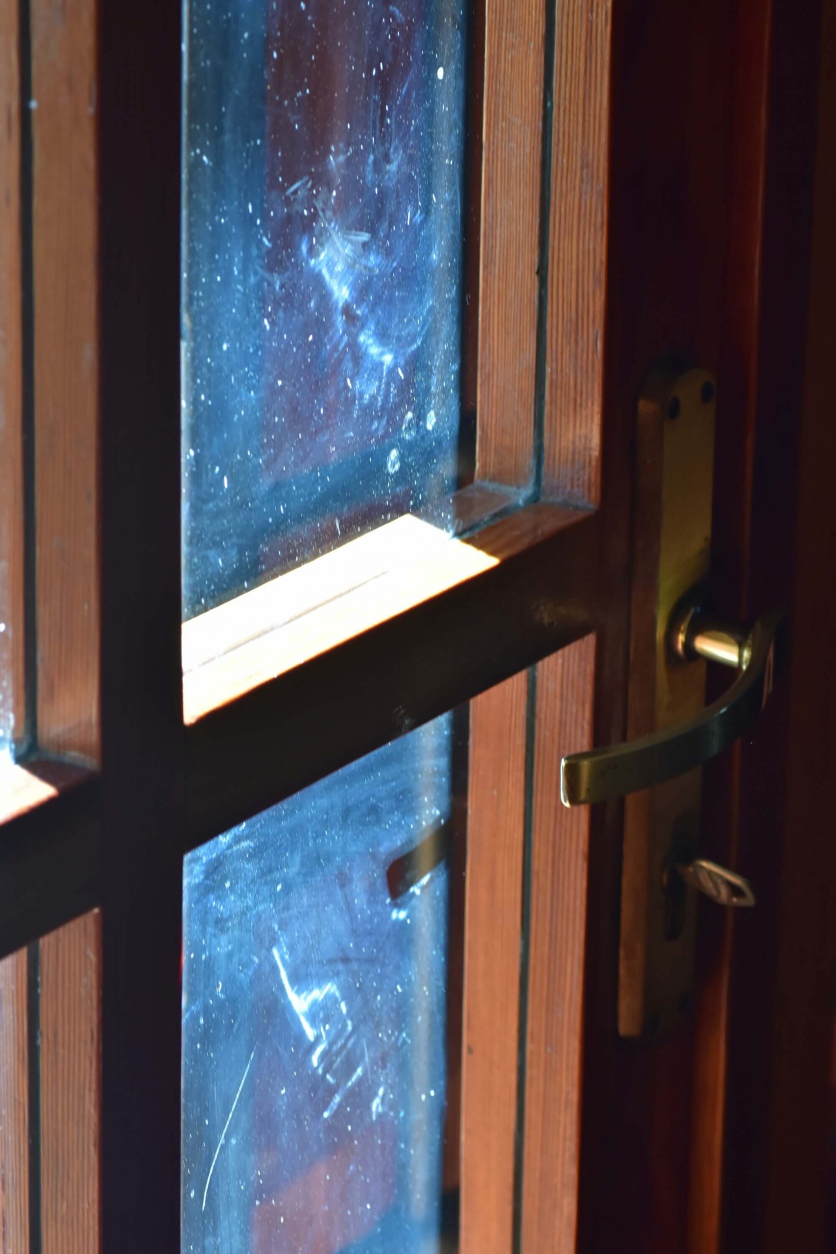 Sunlight falling on closed wooden door