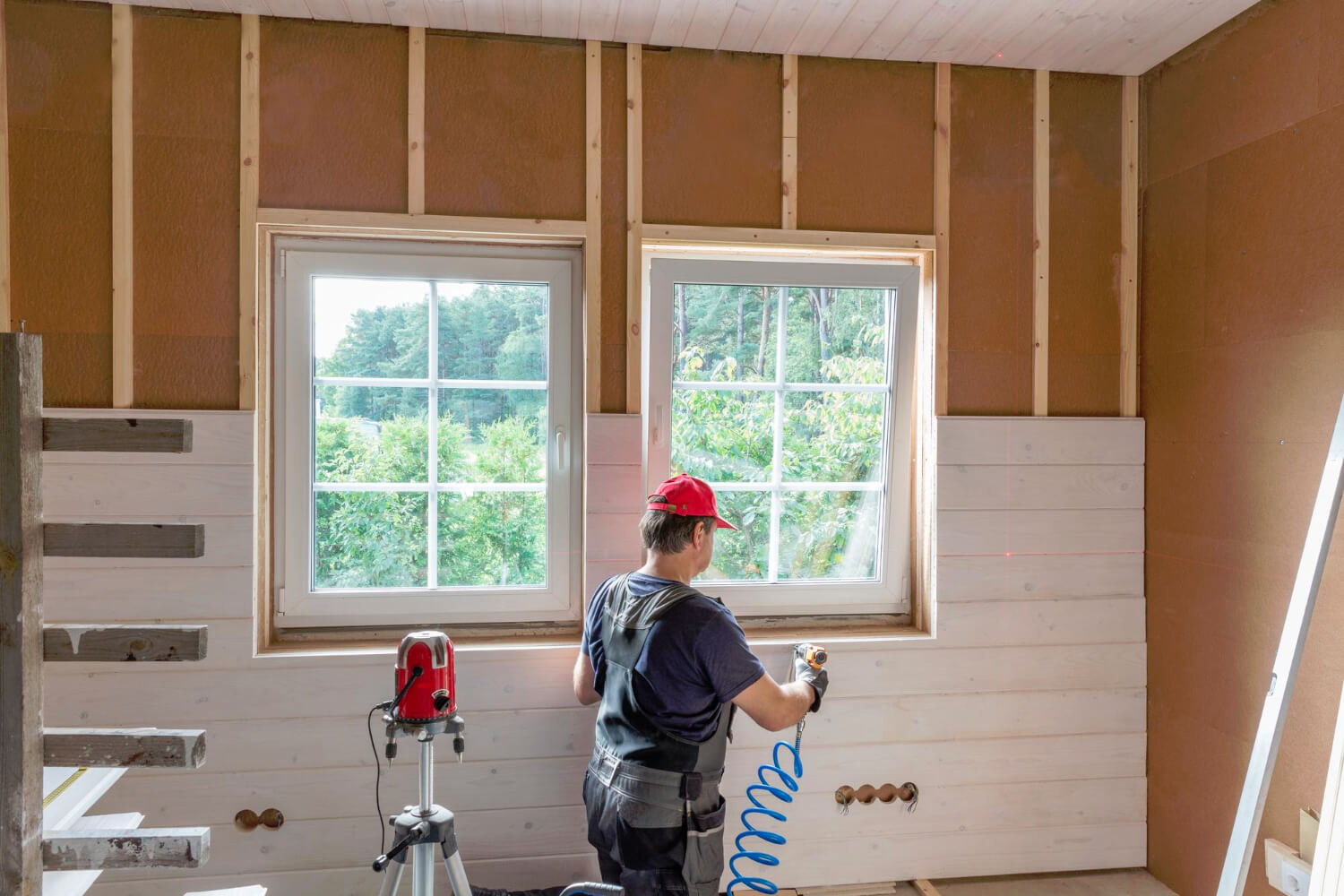 Construction worker thermally insulating eco wooden frame house