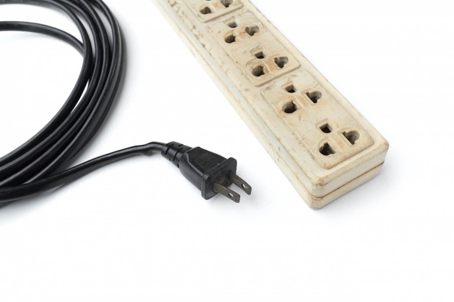 Old and unsafe power strip with illuminated switch