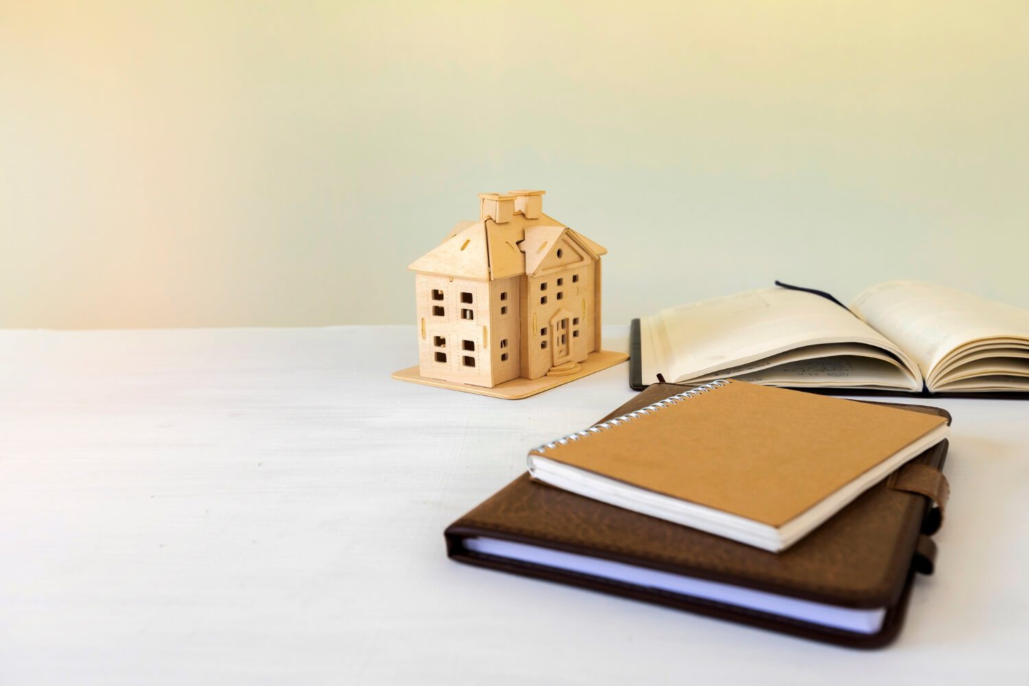House model and book on the desk. real estate concept