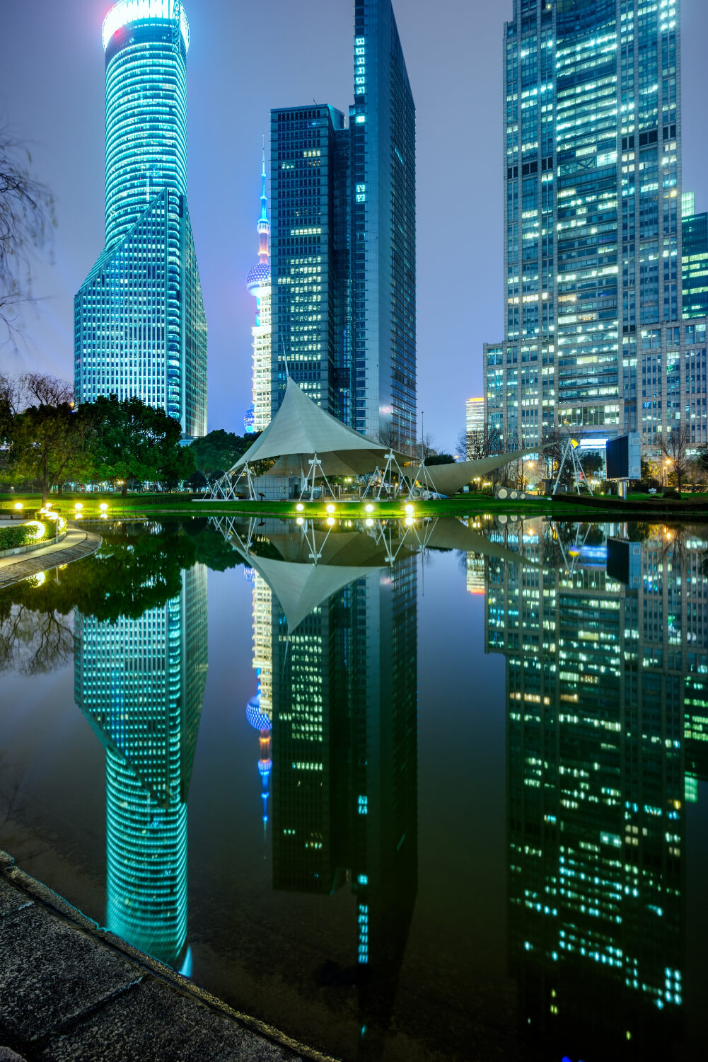 River and modern buildings against sky