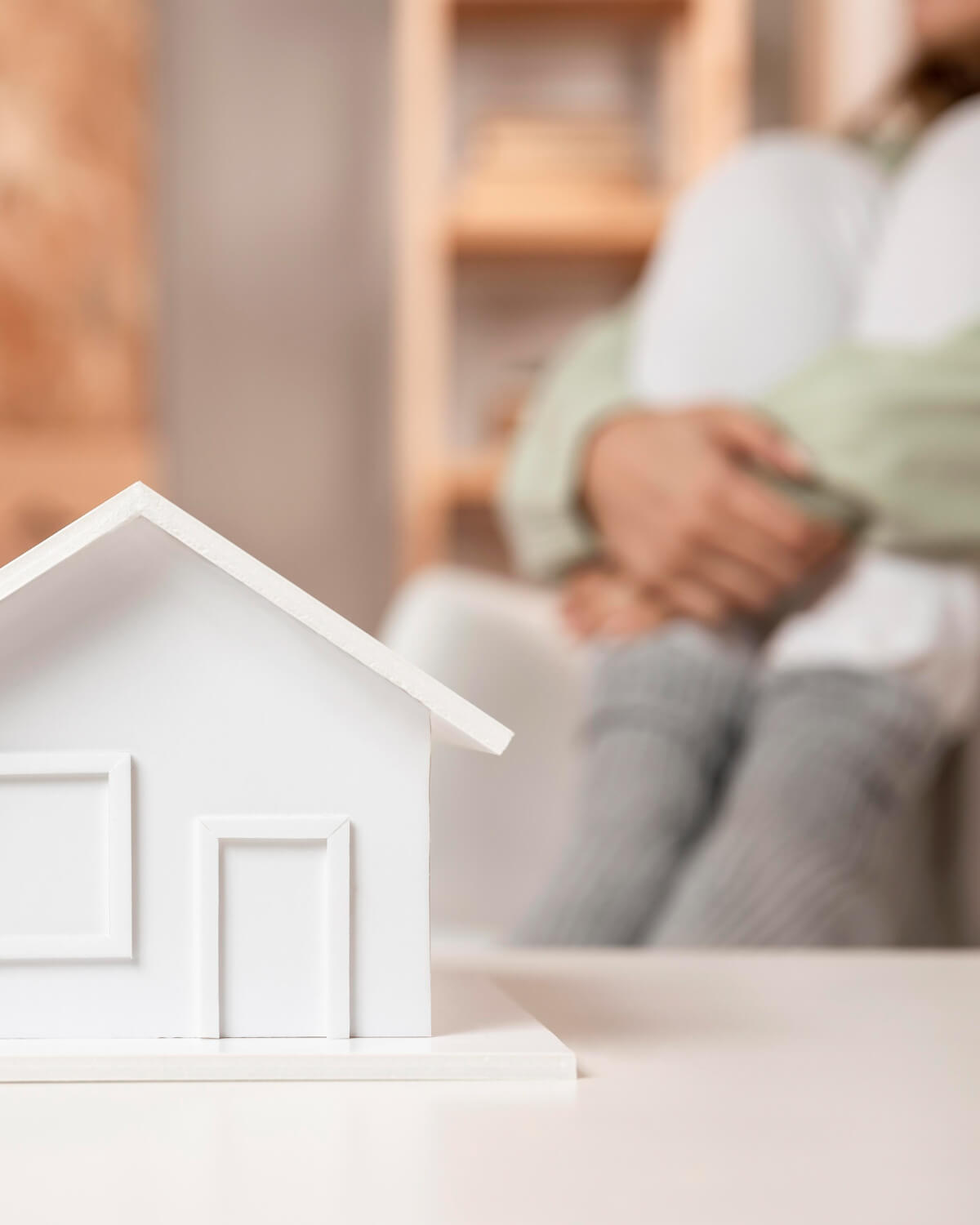 home unsurance: tiny white house in table