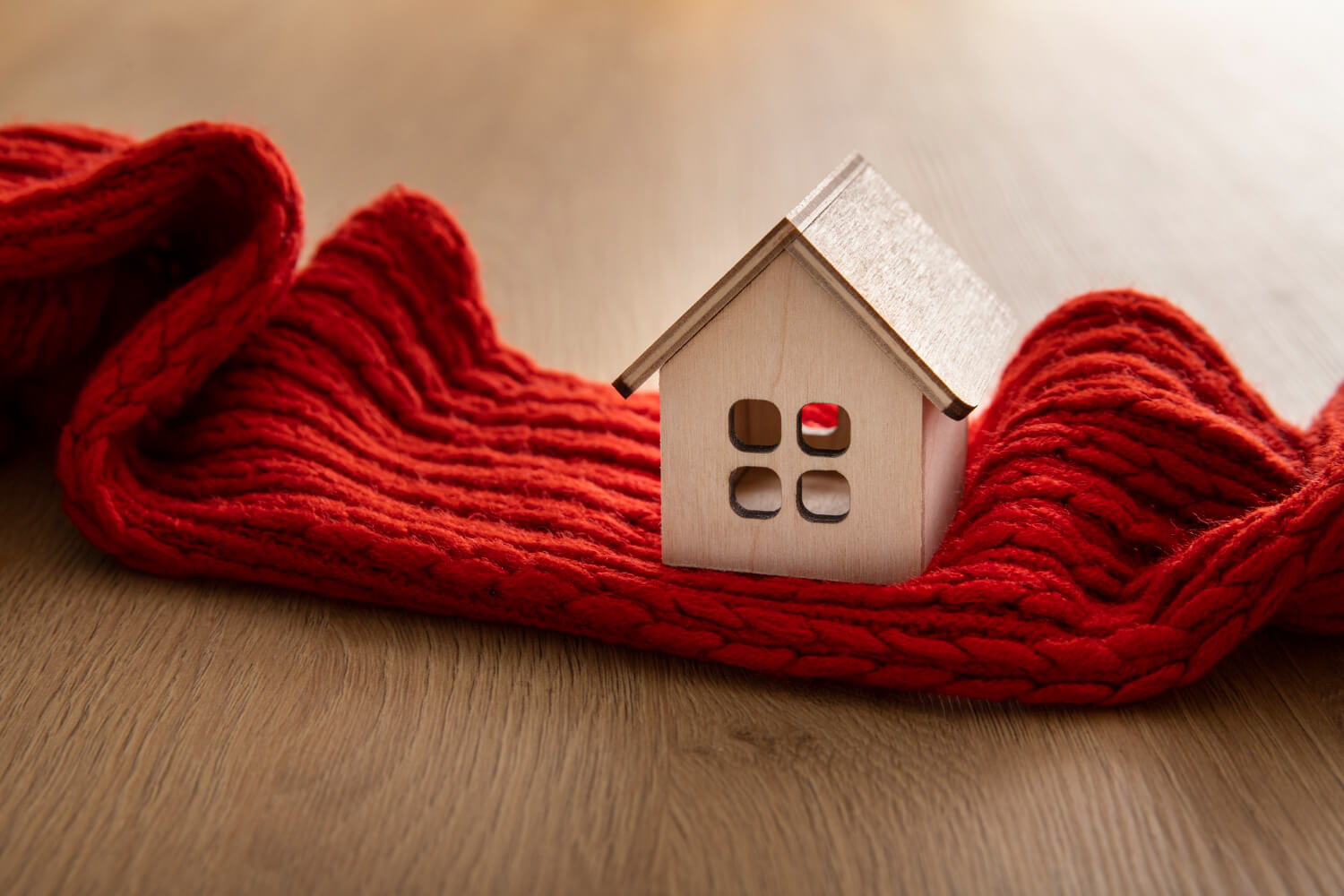 home insurance: wooden tiny house with red scarf